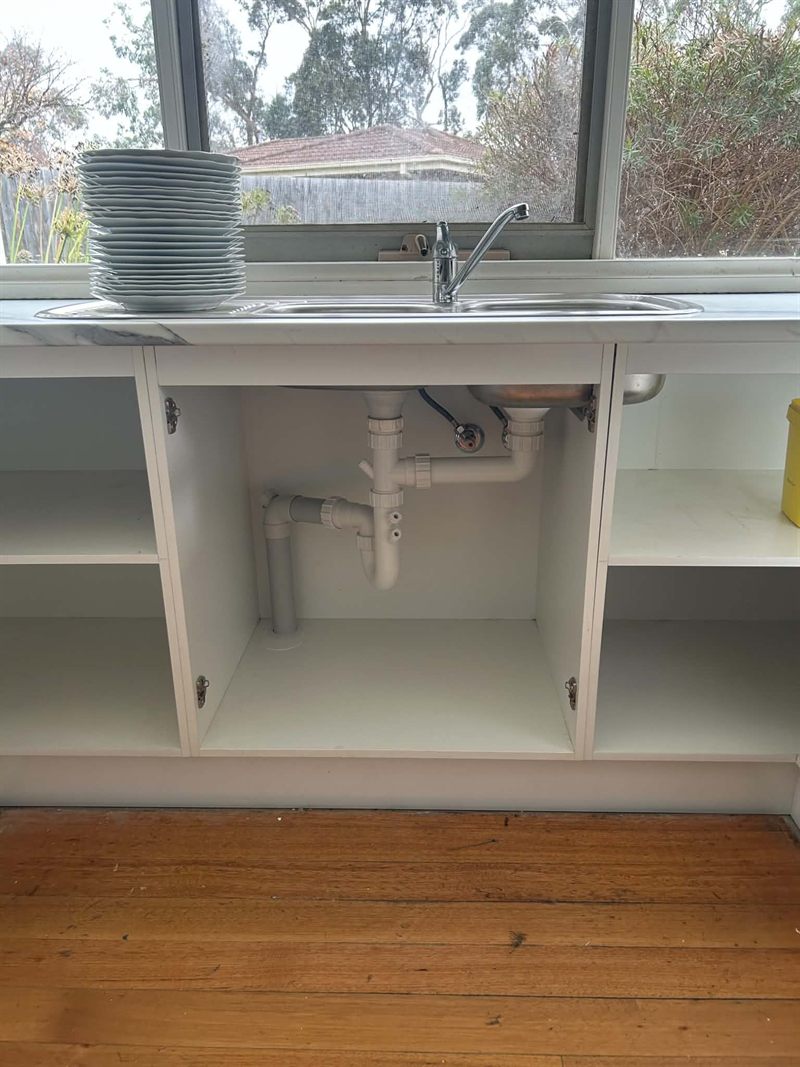 New kitchen sink and mixer fitted, with the waste and flexible connections run neatly in the cupboard below